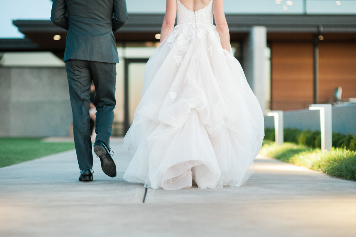 bride and groom walking towards the front door of ponzi winery