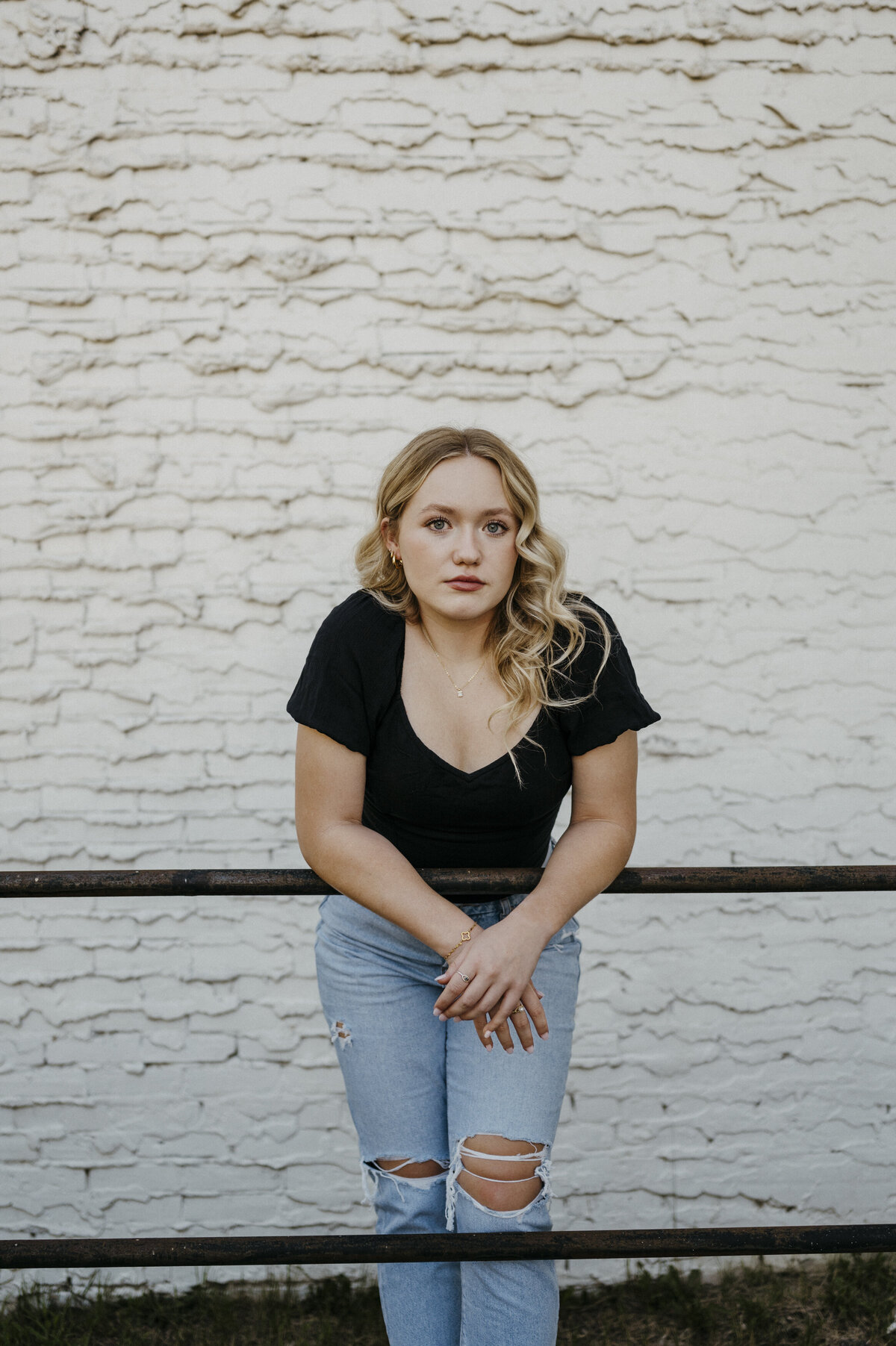 Girl posing by a railing