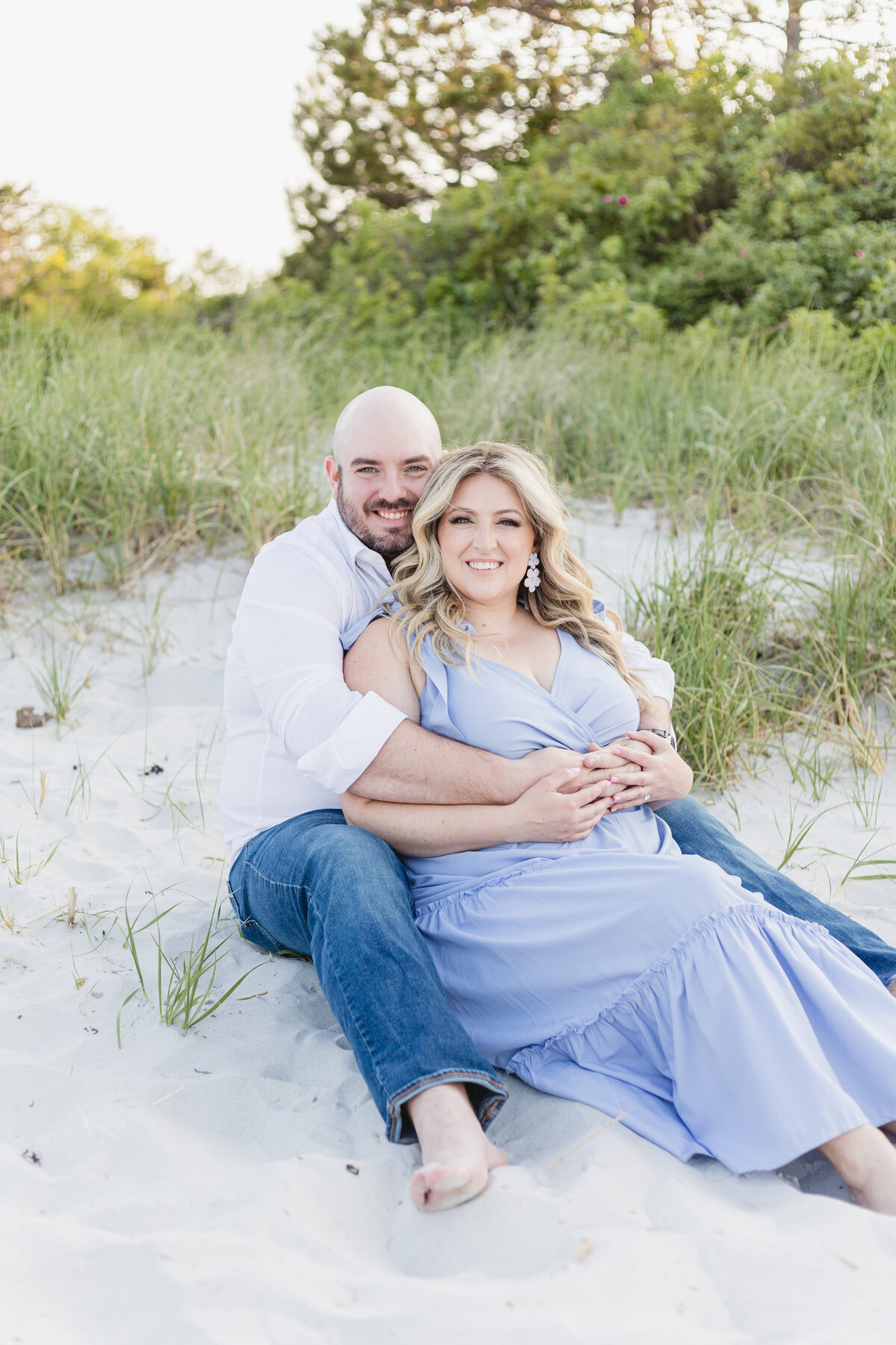 A couple cuddles on the dunes of Wingearsheek beach