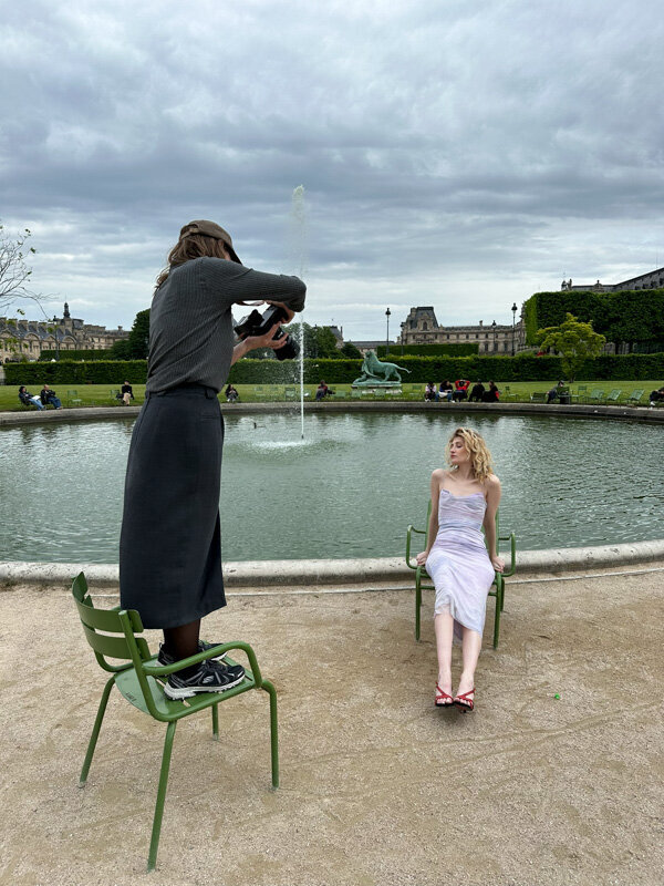 A female photographer is working with a model for shoebrand Jan Jansen in a parc in Paris