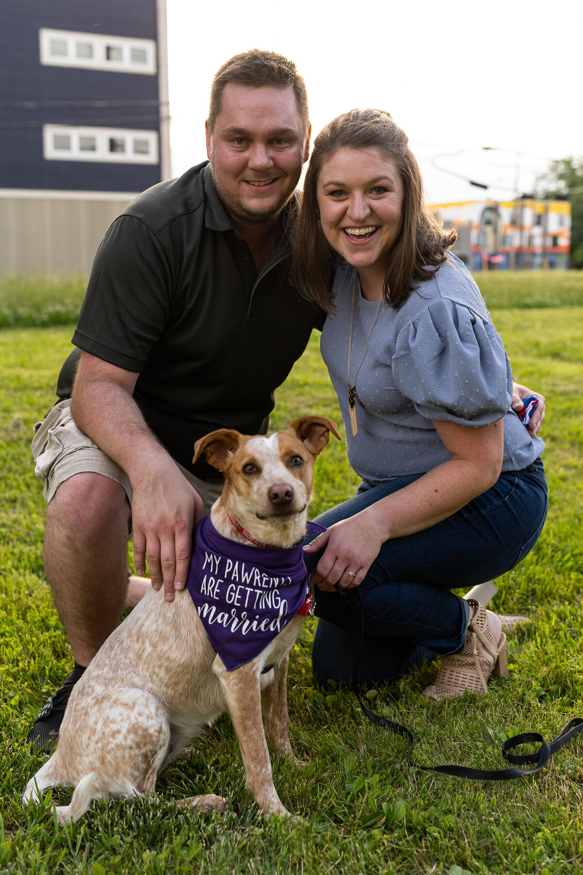 Couple poses with their pup at engagement session in Franklinton Columbus Ohio