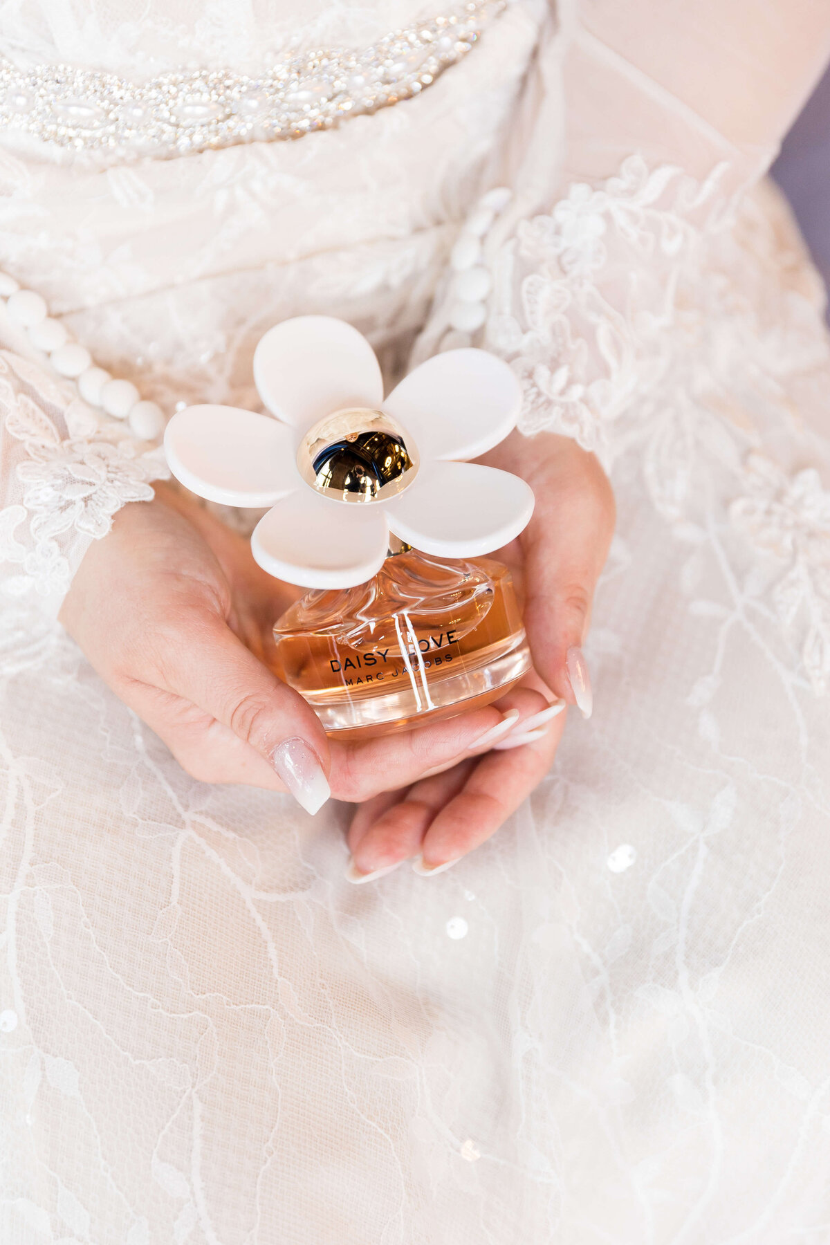 Bride holding perfume  bottle