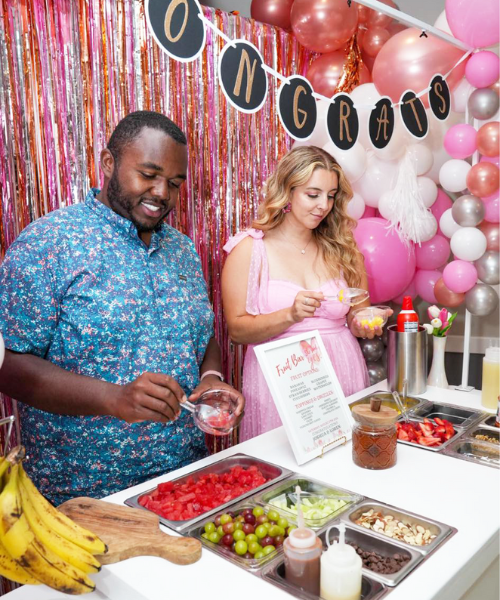 Couple enjoying fresh fruit snack cart setup