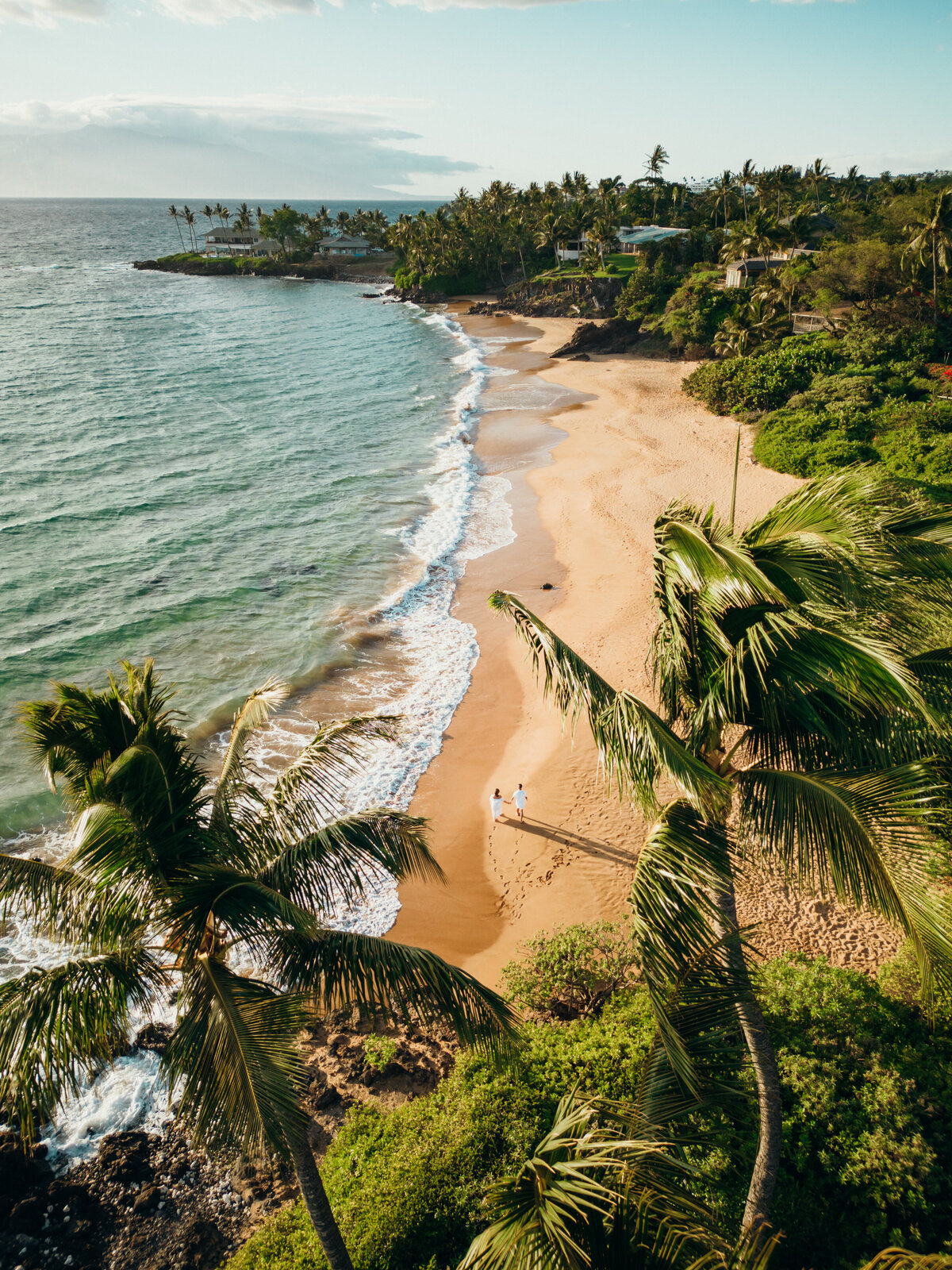 Maui Couples Photographer captures couple walking hand in hand on watefront