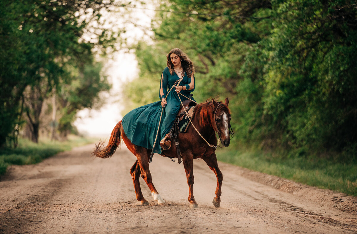 girl riding reining horse in road