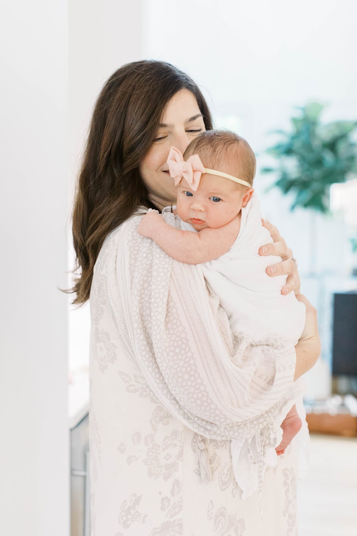 mom holding baby in home session