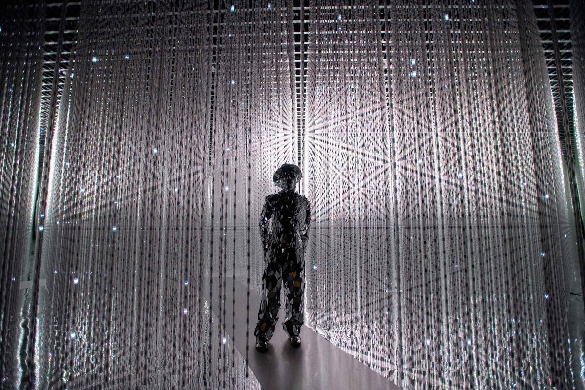 The Future World Exhibit at the Art Science Museum is the first permanent collection. A statue surrounded by hanging crystals