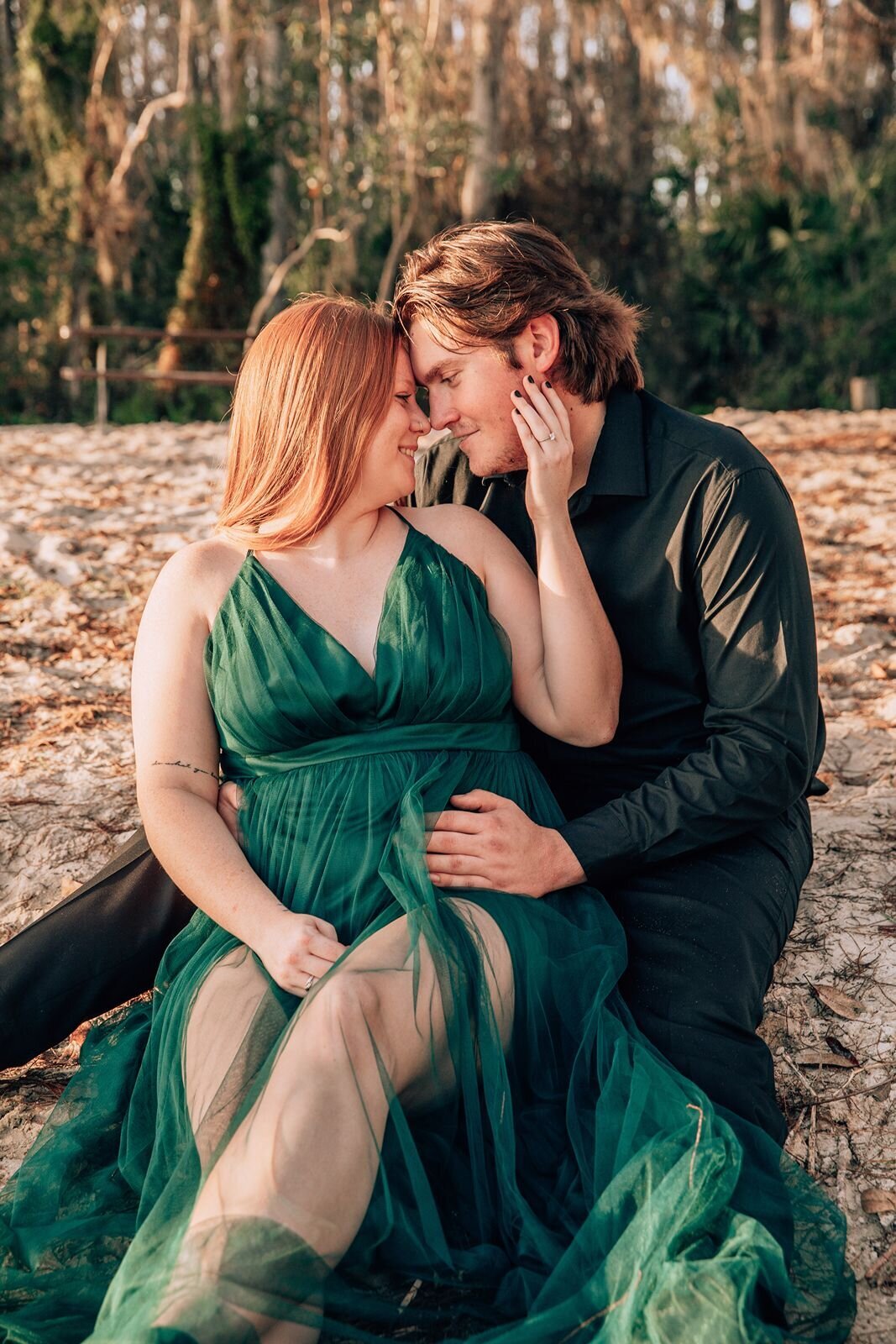 engaged couple touching foreheads and smiling at eachother