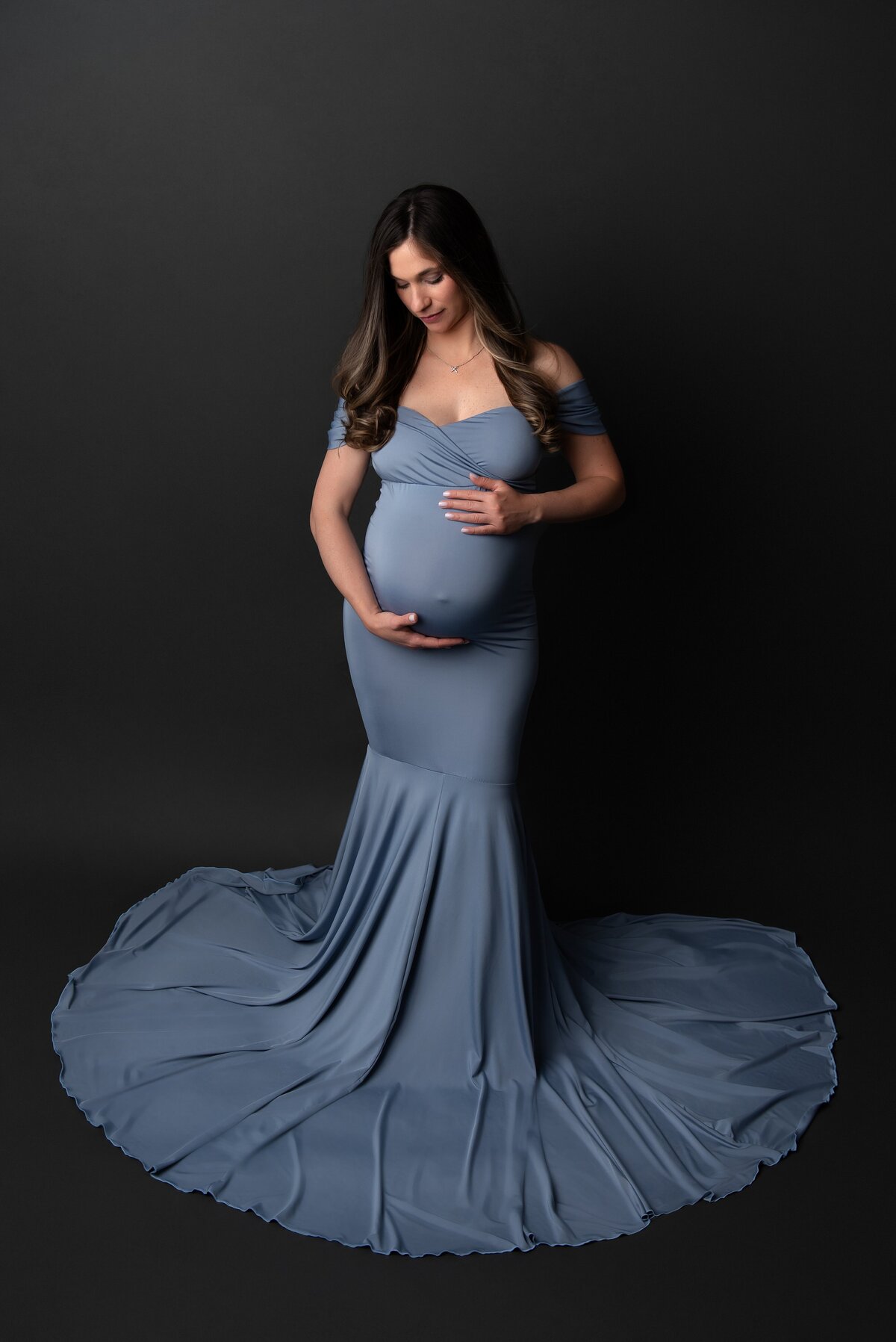 pregnant mom in blue maternity gown in portrait studio