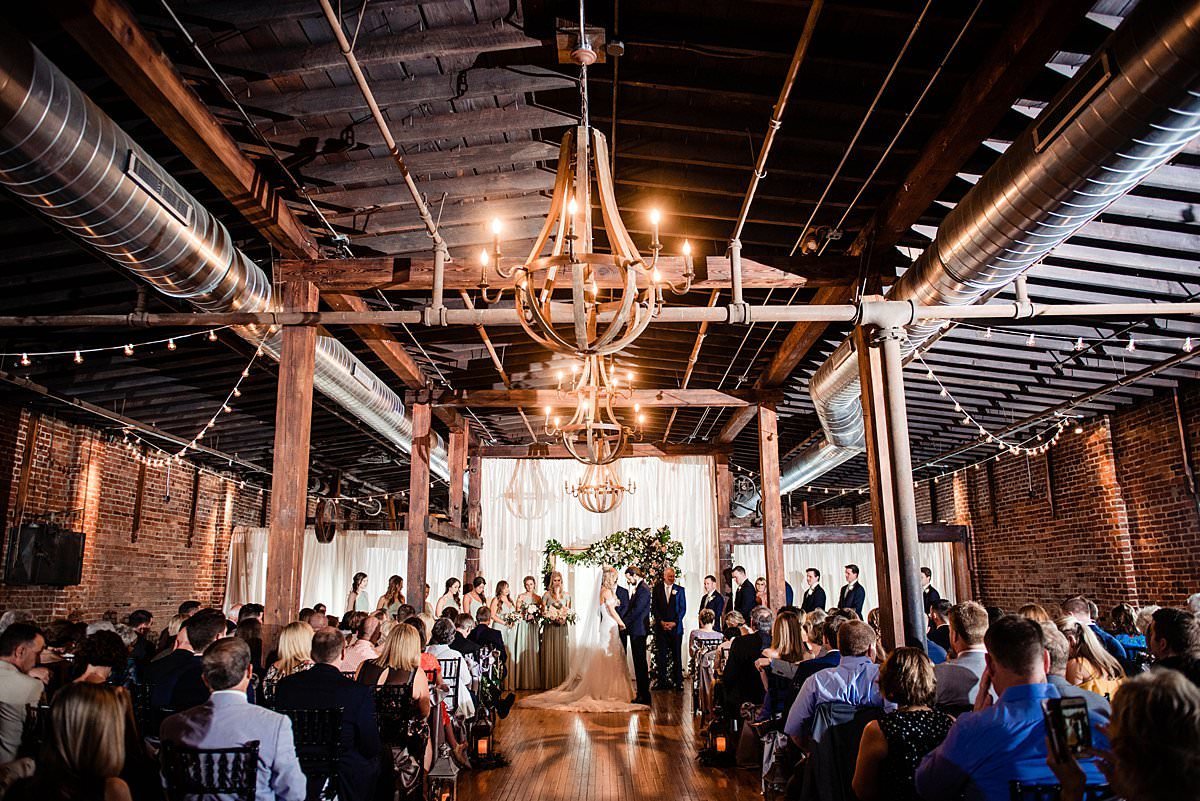 Ceremony inside of Cannery ONE candid moment of vow exchange