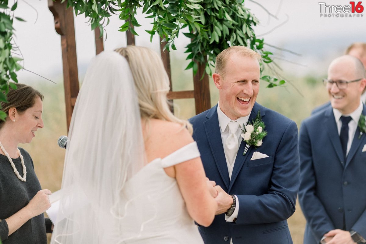 Groom shares a laugh during the ceremony