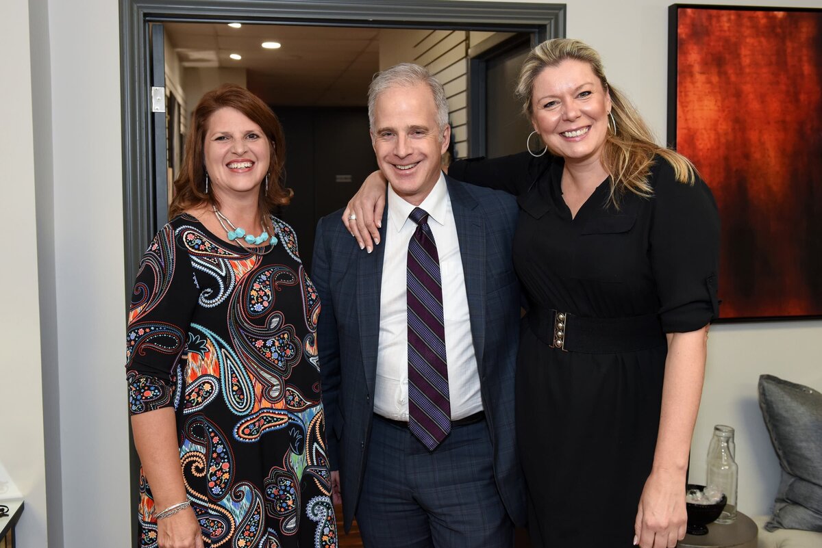 Three attendees posing together at a networking event in Toronto