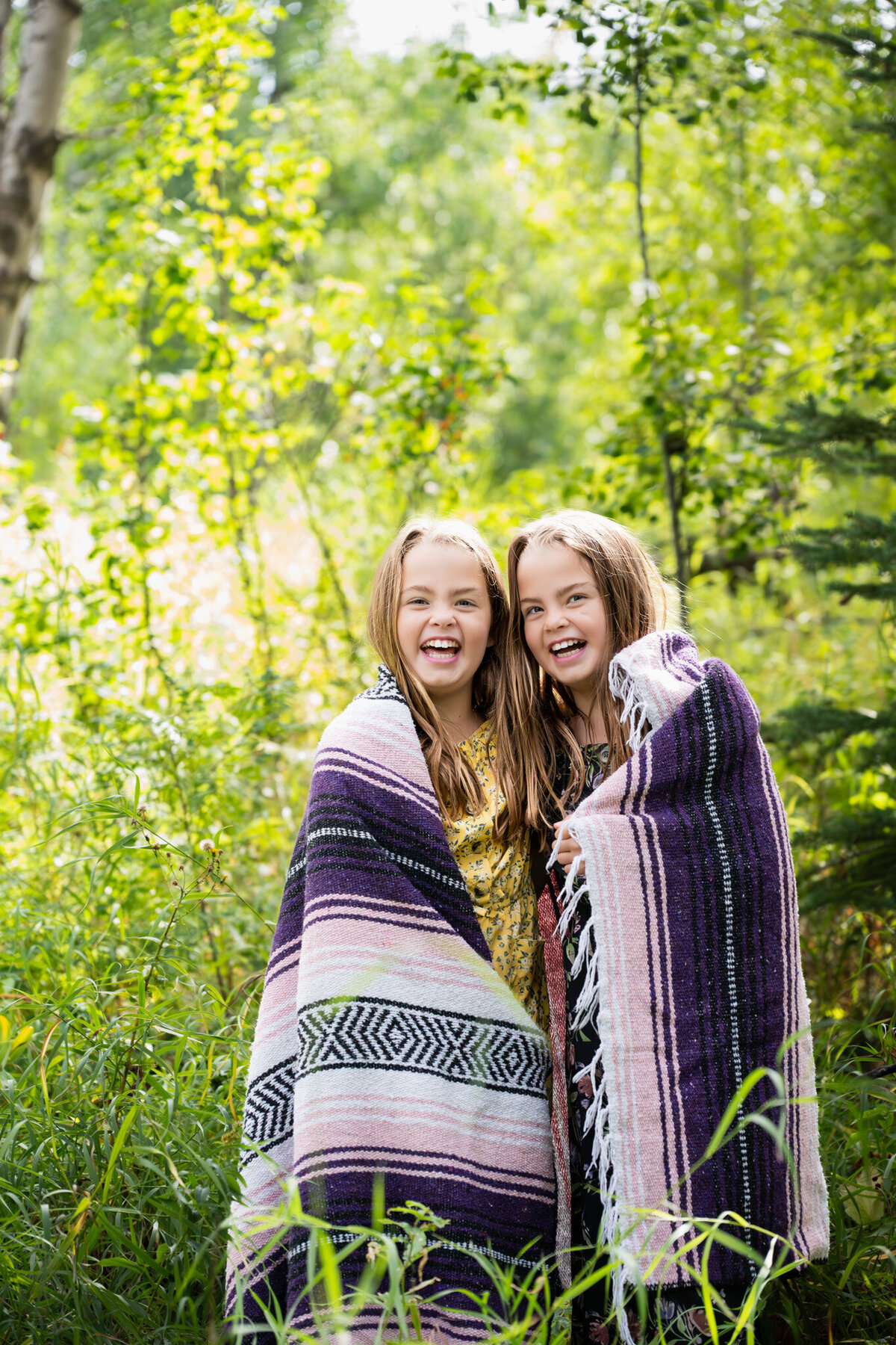 twins-in-a-blanket-in-the-woods