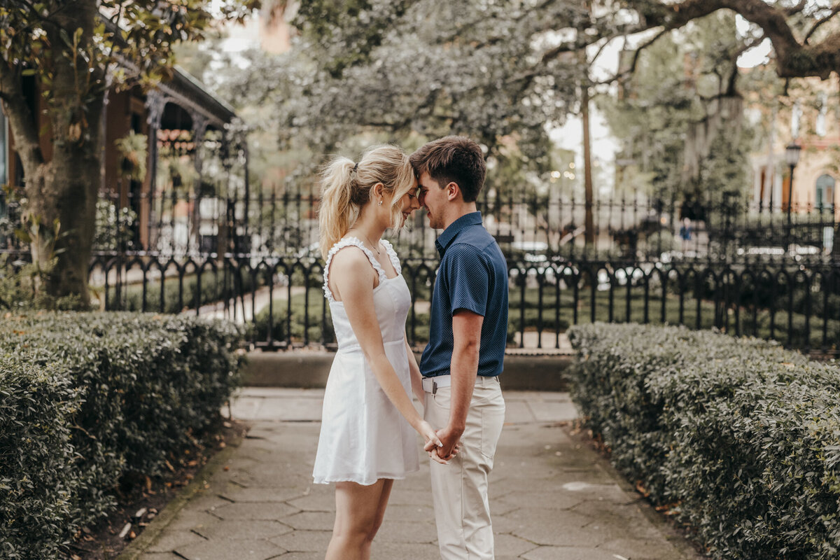 couple walking along hand in hand an engagement session hilton head