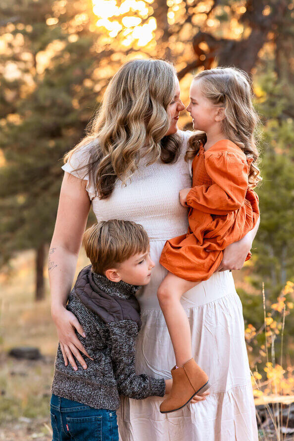 A mom hugs both her kids in Indian Hills, Colorado.