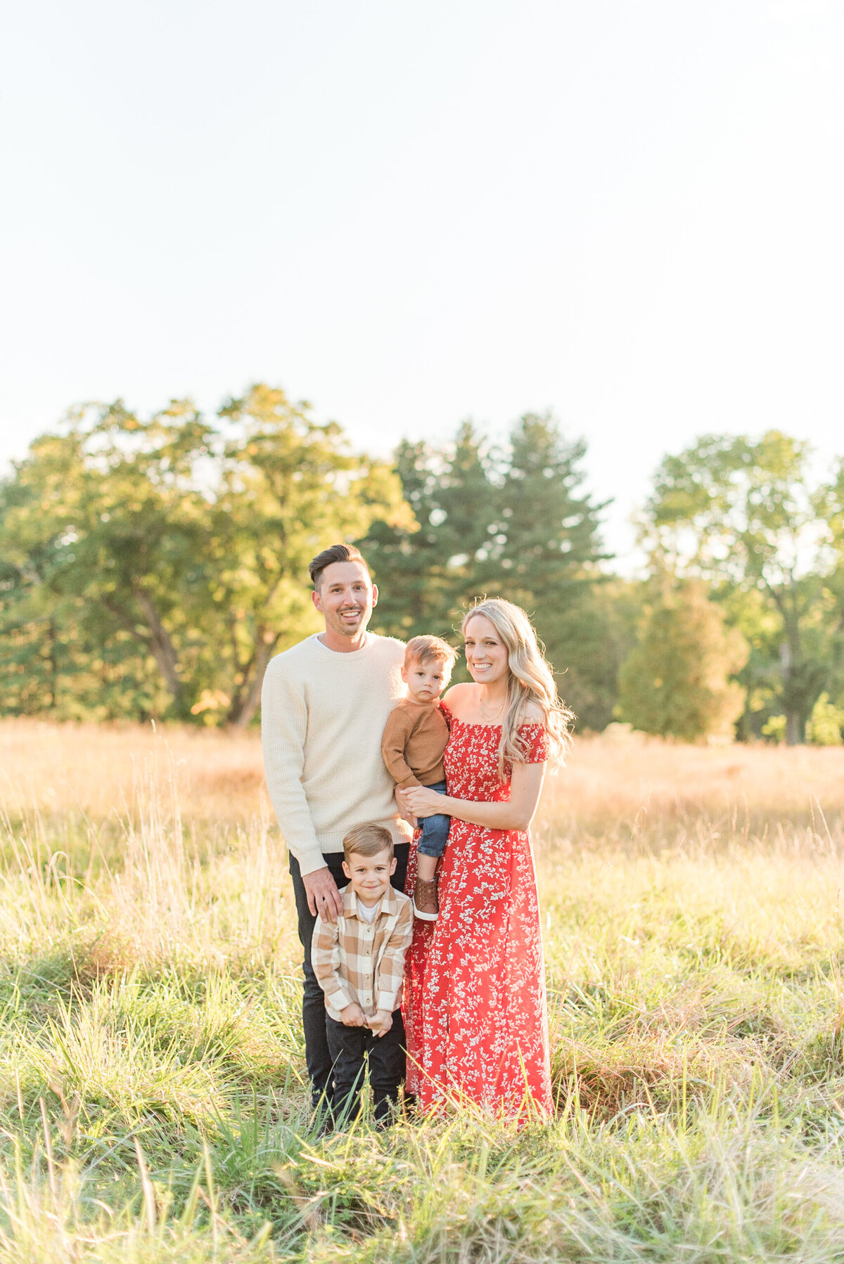 family of four red dress and  neutral boy and husband clothes