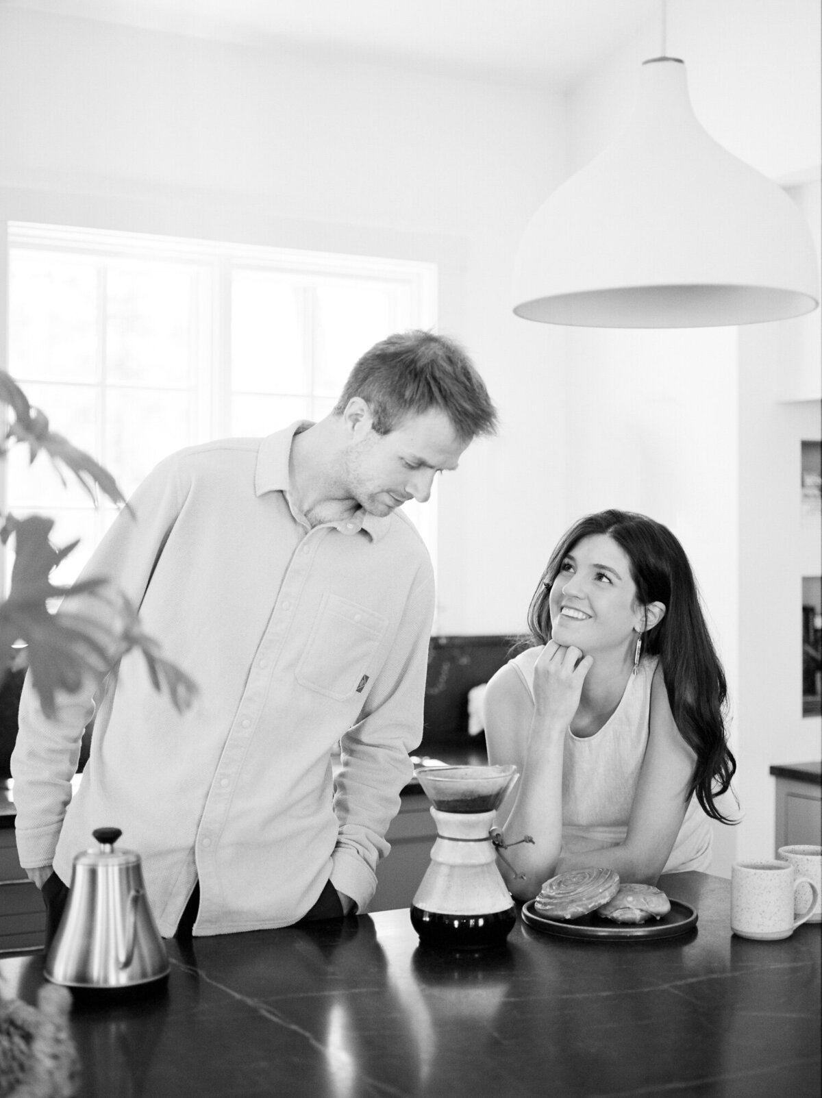 smiling couple shares coffee at Fernhaus, Northern Michigan during designer interior branding photos on film
