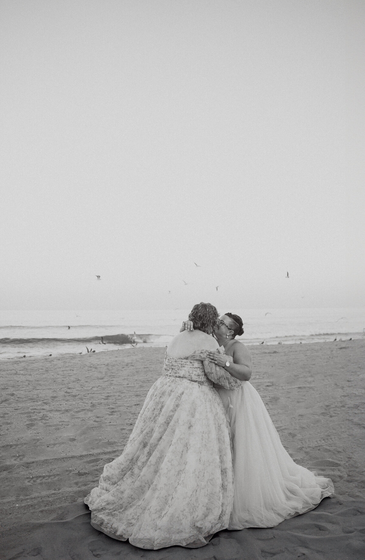 A newlywed couple kissing on the beach 