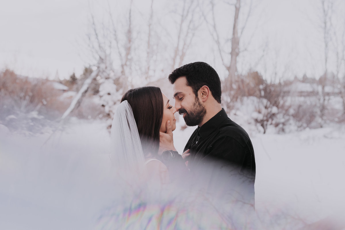 Lake Tahoe wedding photographers couple embraces in snow at Crystal Peak Park in Reno