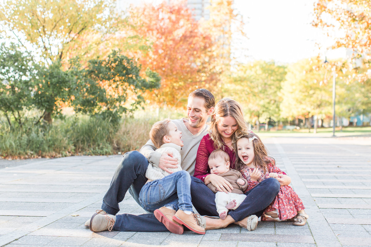 family sitting on the ground in a Boston park