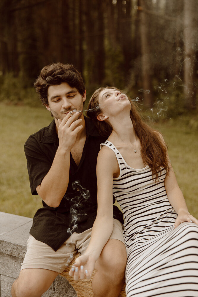 Couple smokes joint together during engagement photos
