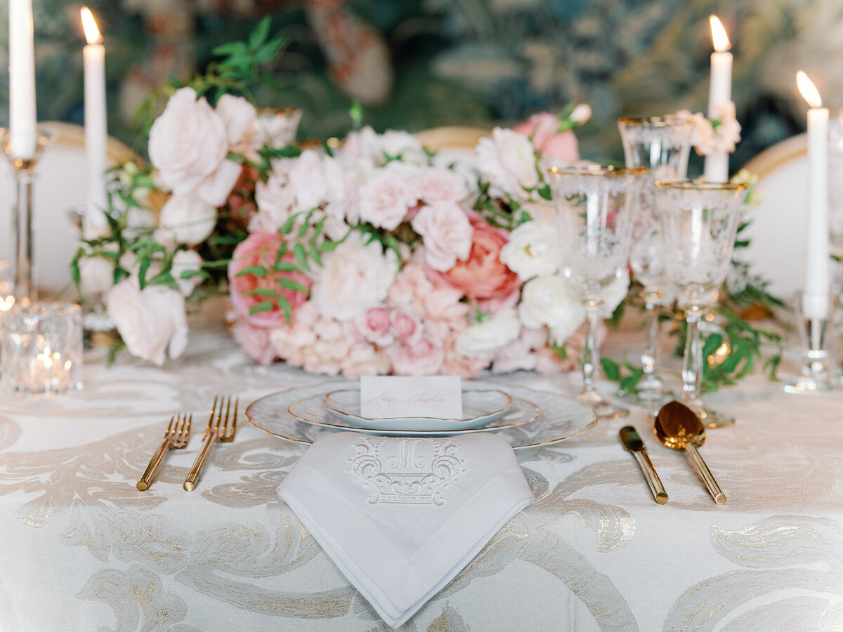 A wedding table scape with blush floral touches and gold touches