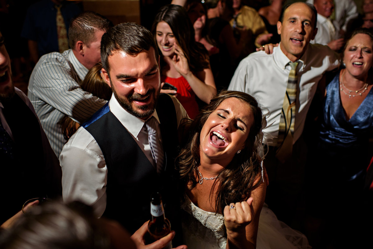 A bride and groom singing their hearts out to the last song at their reception at the Union Trust in Philadelphia.