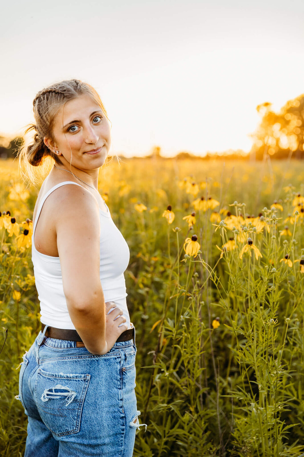 teen girl posing in a field of black eyed susans in a field near Oshkosh