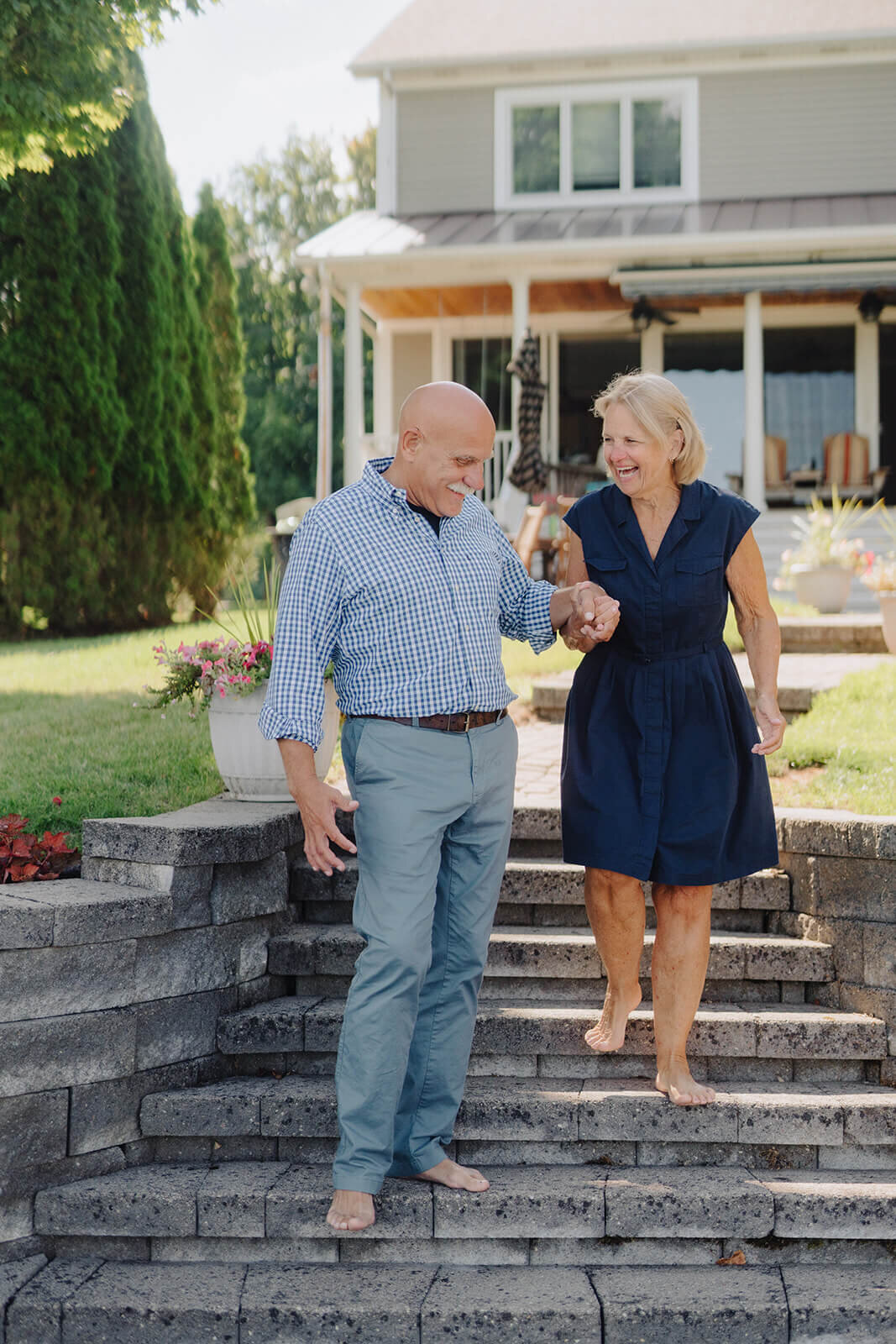 Man helping woman down the steps at generational photoshoot in Finger Lakes, NY