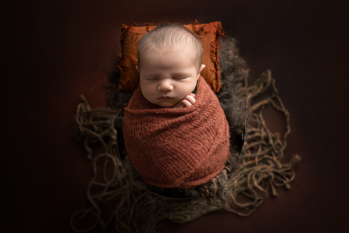 Newborn baby rustic basket orange wrap Cedar Park professional photographer