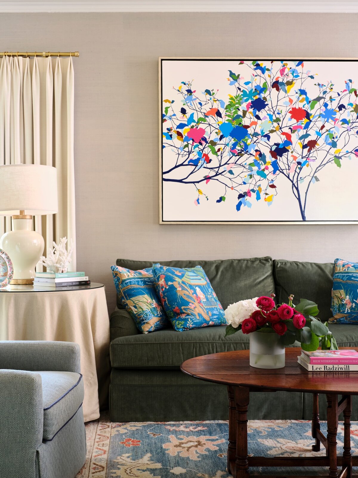 the keeping room interiors morningside green sofa and roses on round wooden coffee table