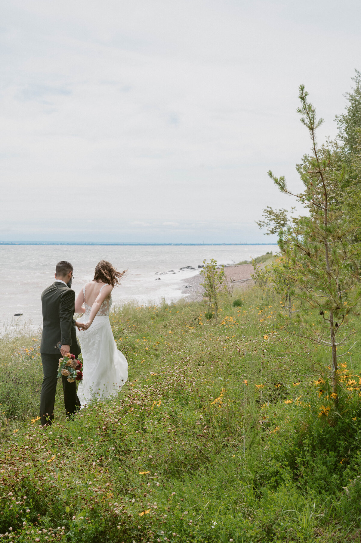 couple skipping in the flower field