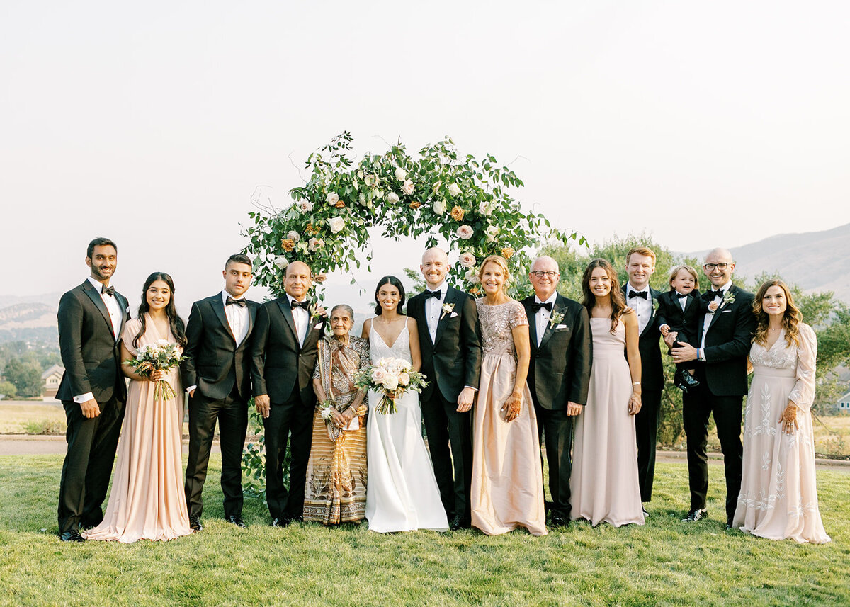 Wedding party with a custom floral arch