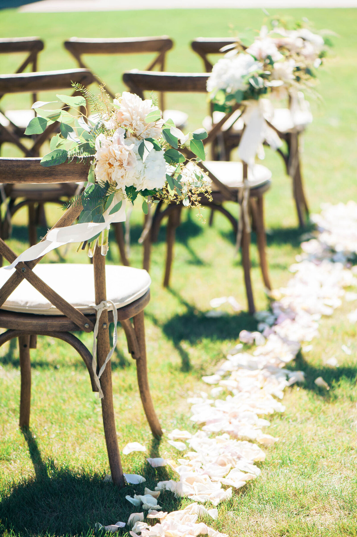 ceremony chairs with flowers and aisle petals at ponzi vineyard 