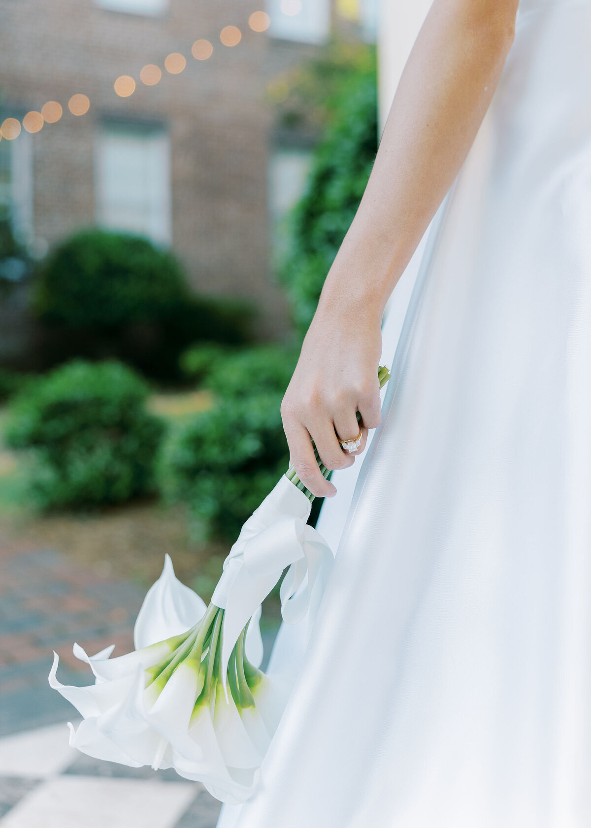 close up of a bride in her wedding dress holding a bouquet