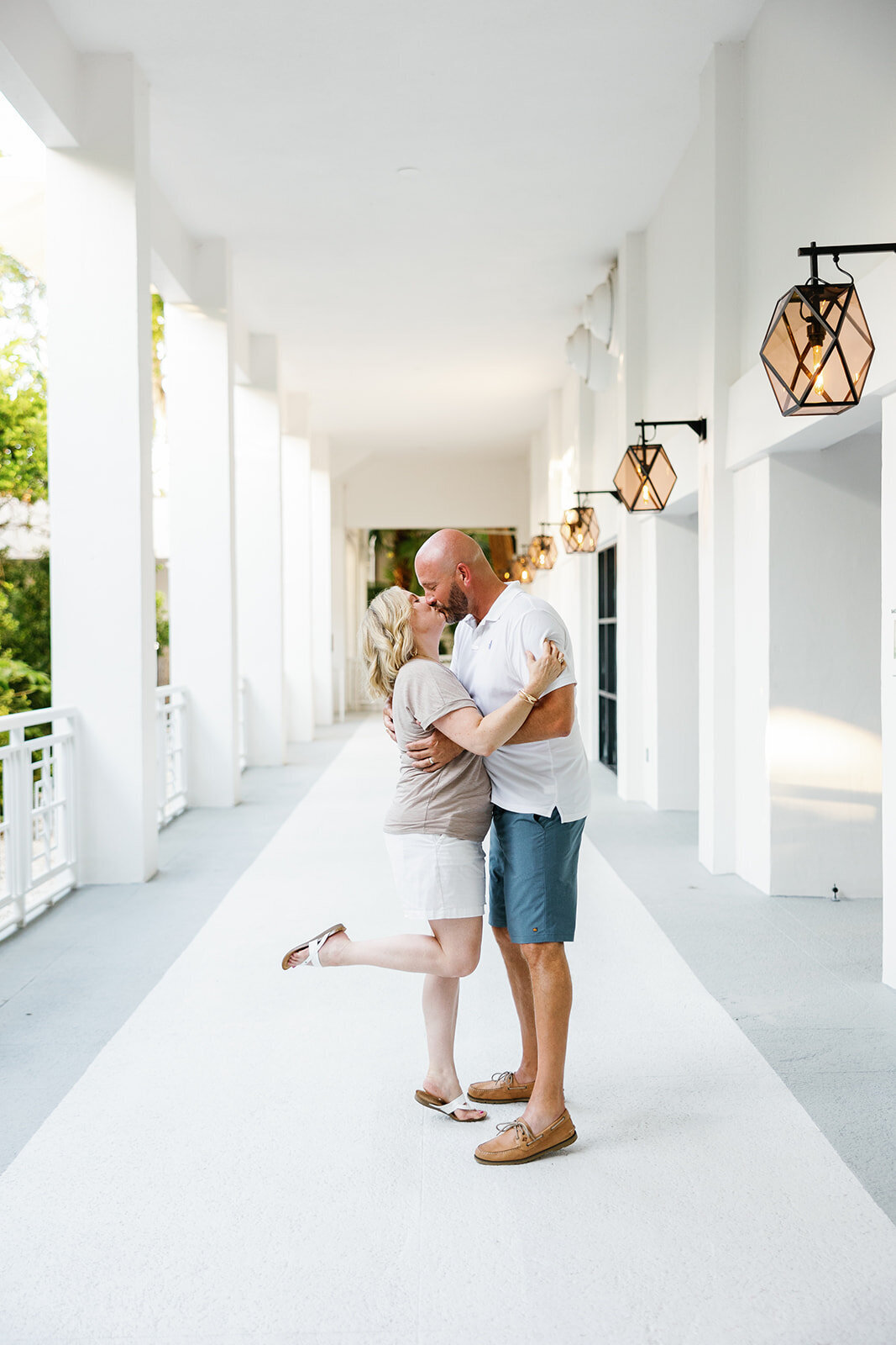 A couple embraces under soft natural light in an elegant hallway during a Florida Keys portrait session.