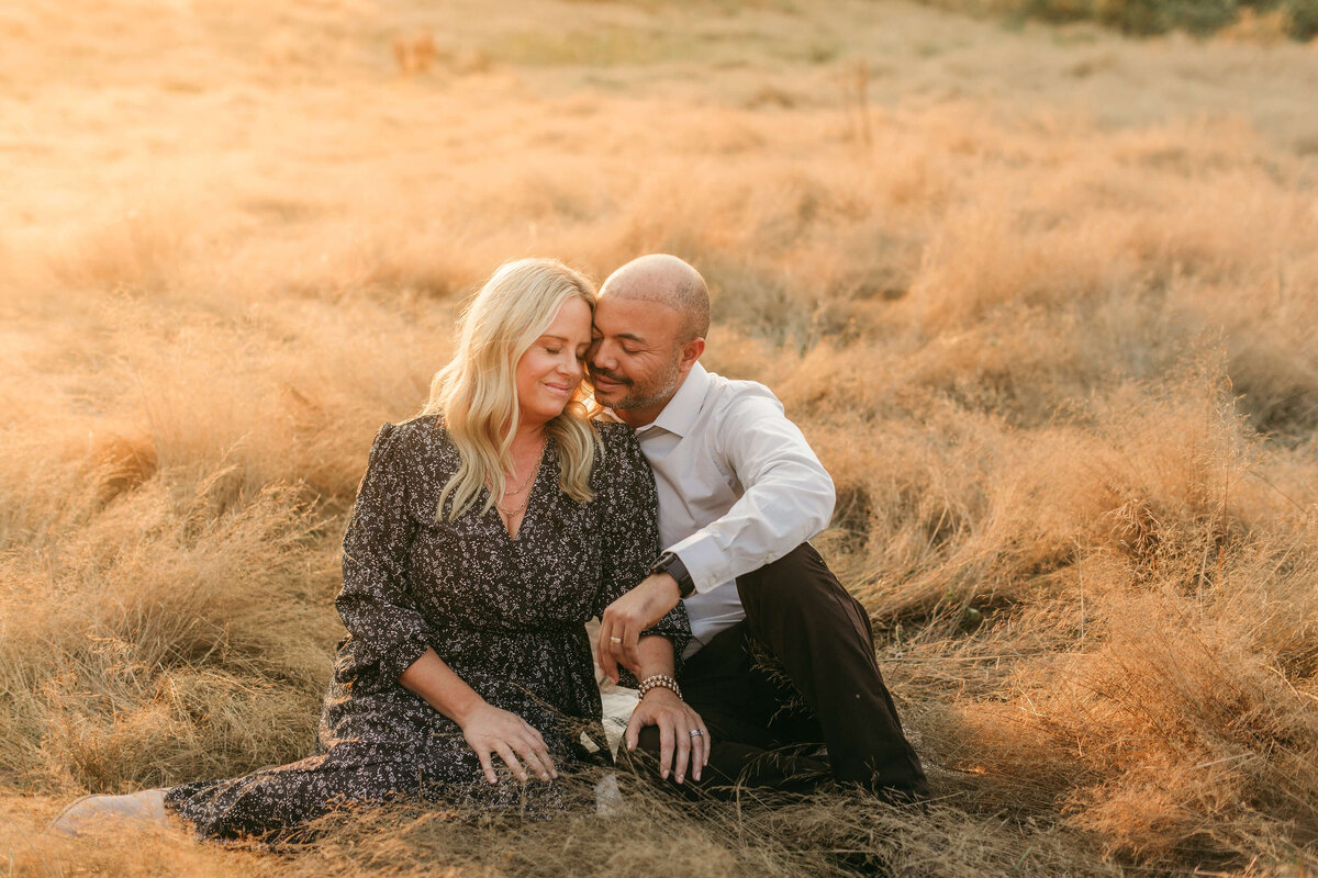 A Woodinville couple cozies up in a golden field