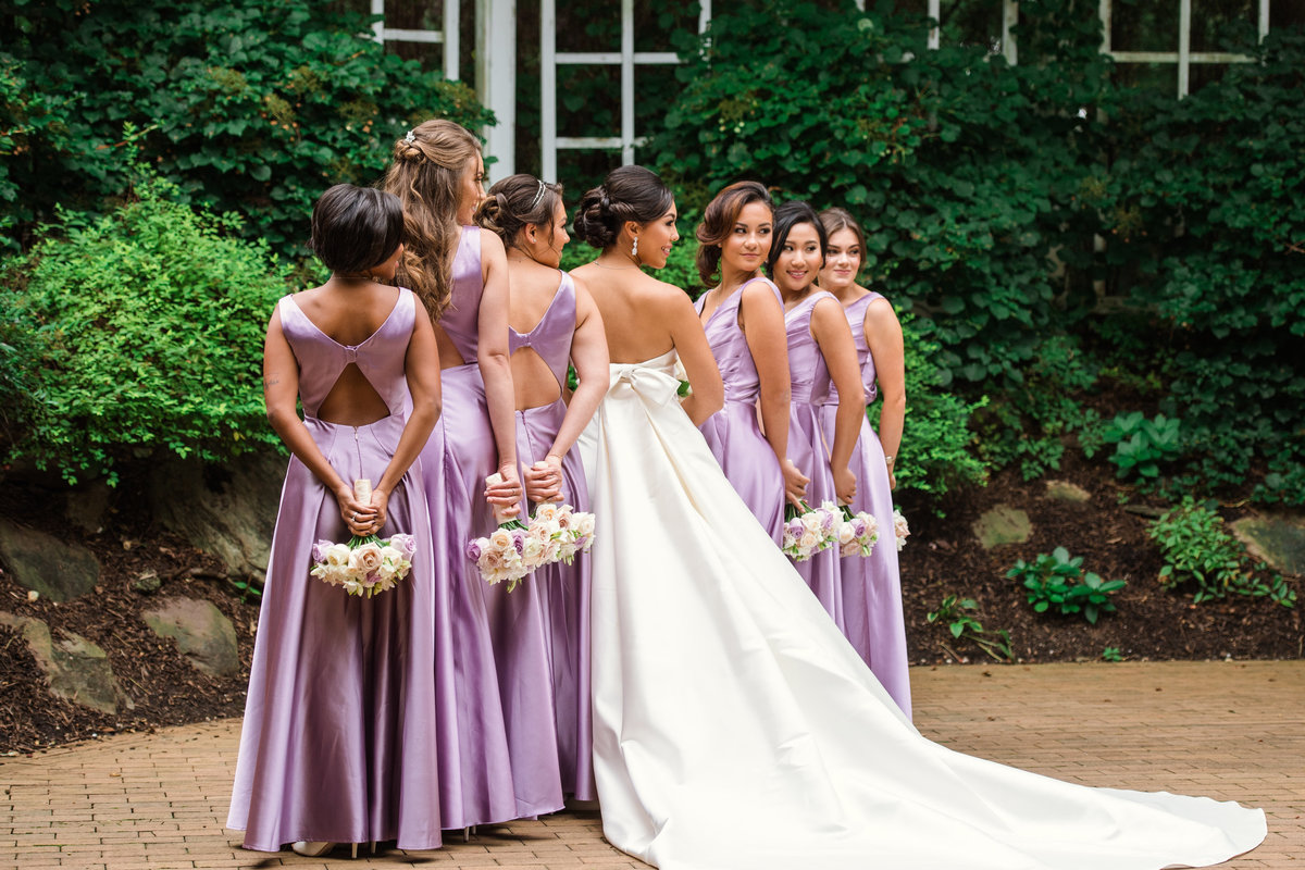 wedding photo of bride and bridesmaids looking back at the camera at The Garden City Hotel