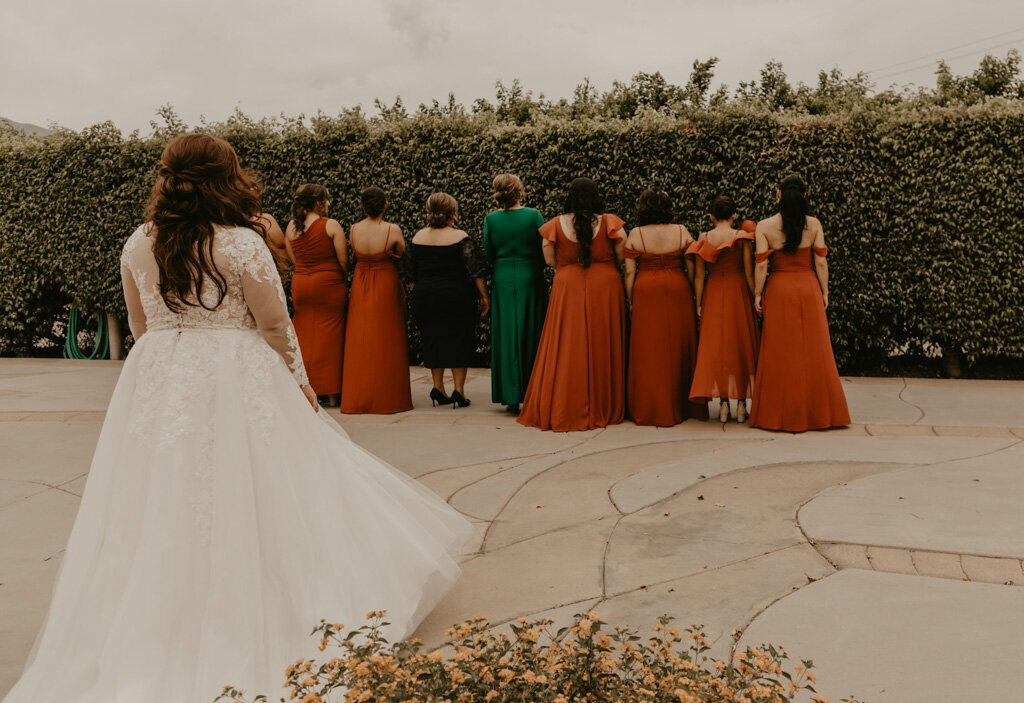 Bride surprises wedding party and mothers with dress
