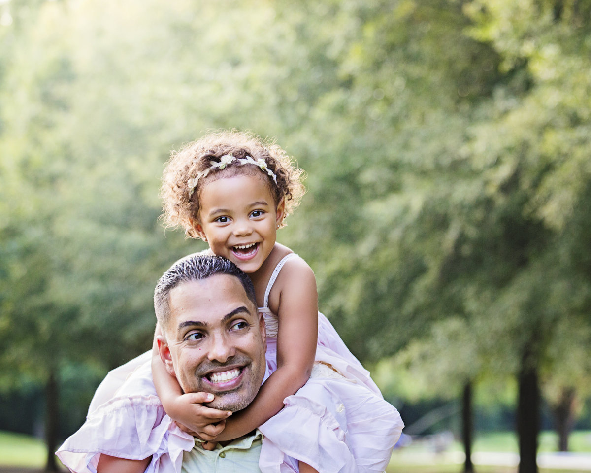 charlotte family photographer jamie lucido creates a playful father daughter image with child on father's shoulders