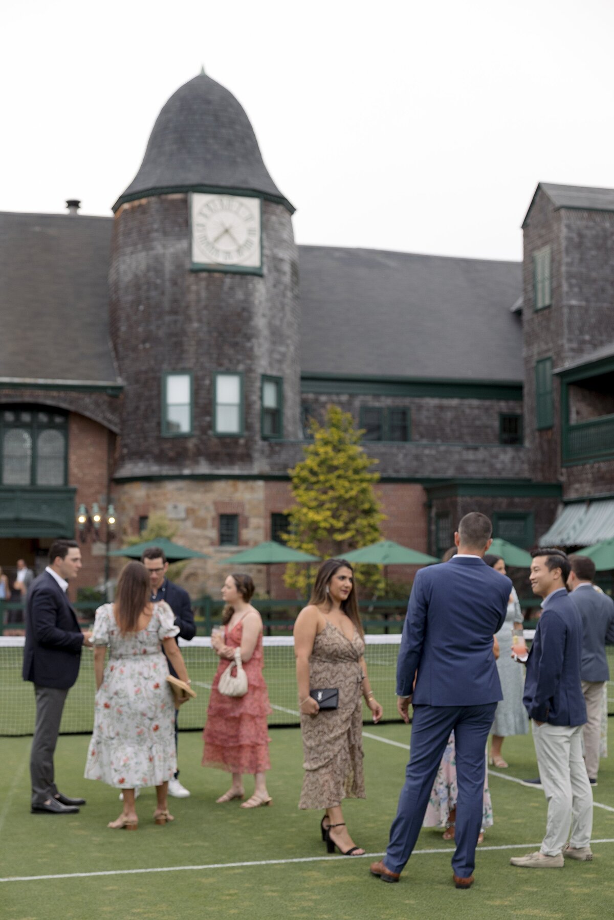 Guests mingle on the lawn of Tennis Hall of Fame Newport Rhode Island.