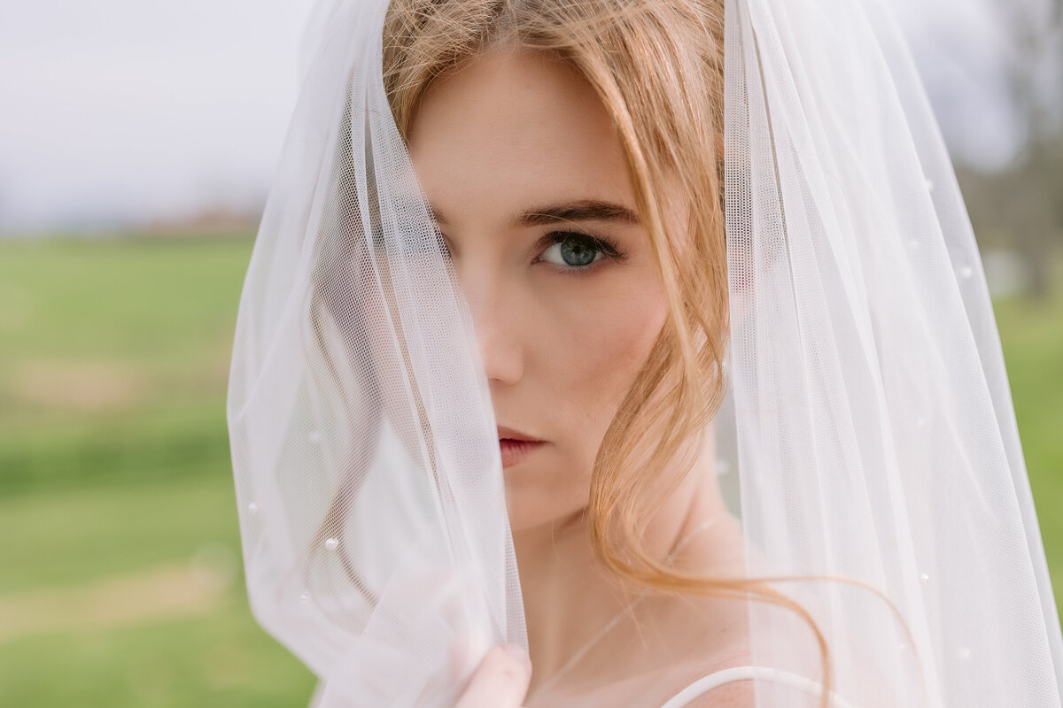 Bride standing with veil over one eye