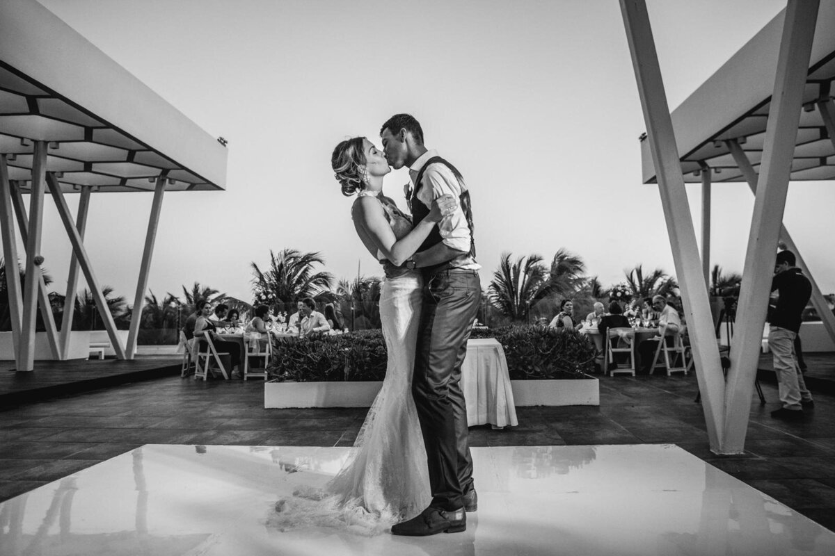 couple sharing their first dance outdoors in a tropical environment