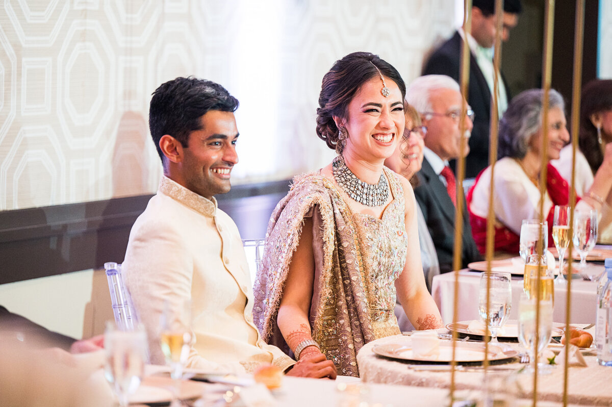 bride and groom listening to wedding toasts