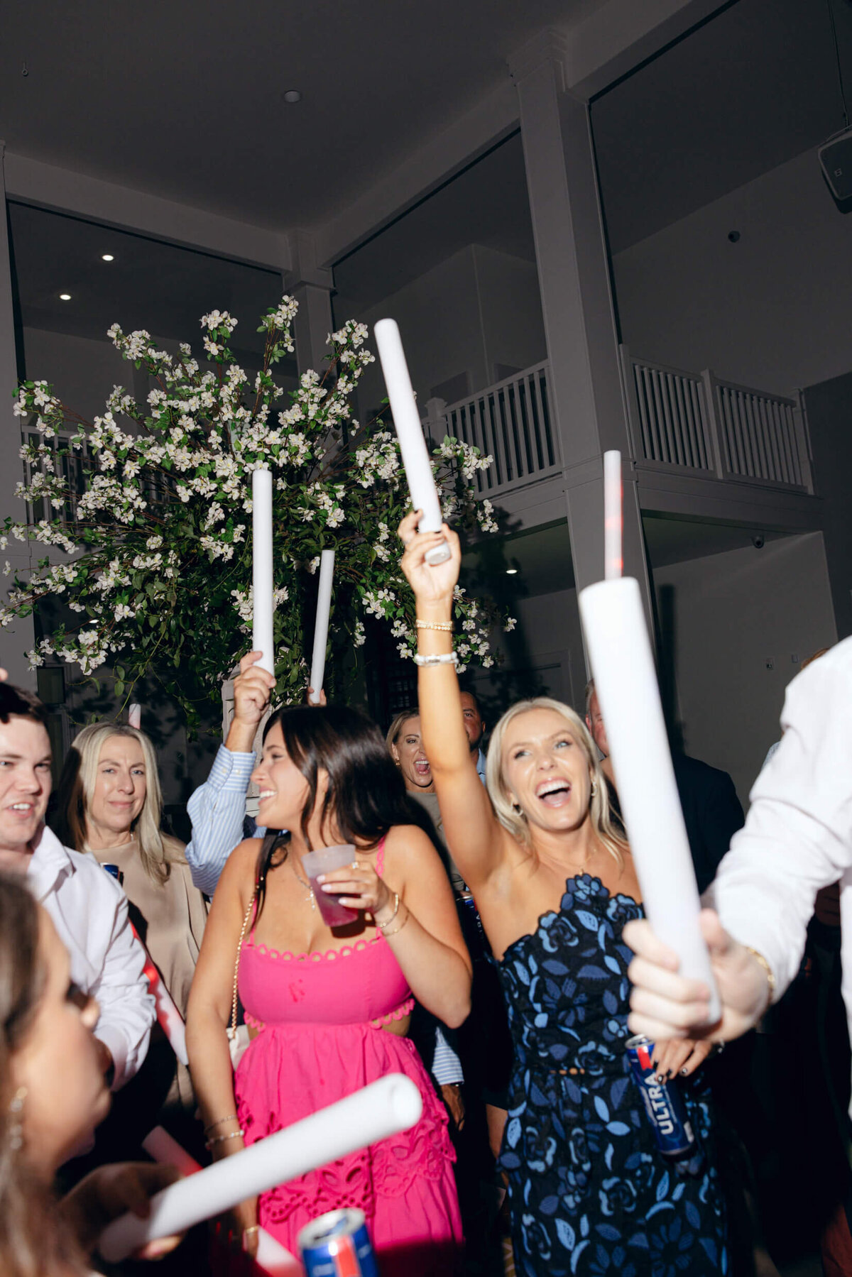 A wedding photo of guests dancing during the wedding reception