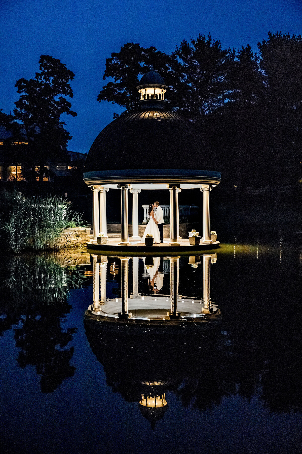 ashford-estate-wedding-couple-kissing-in-lit-gazebo-at-night-by-lake-summer-allentown-new-jersey