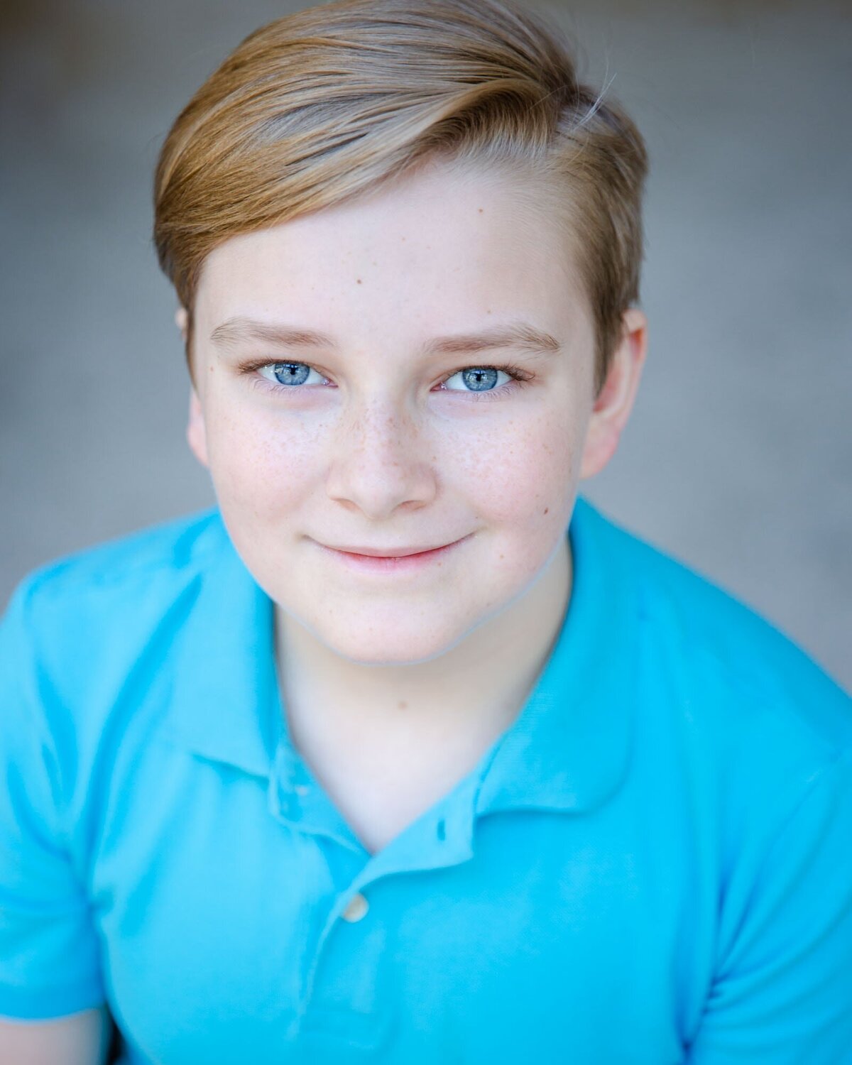 Gorgeous headshot of a blue-eyed boy in blue.
