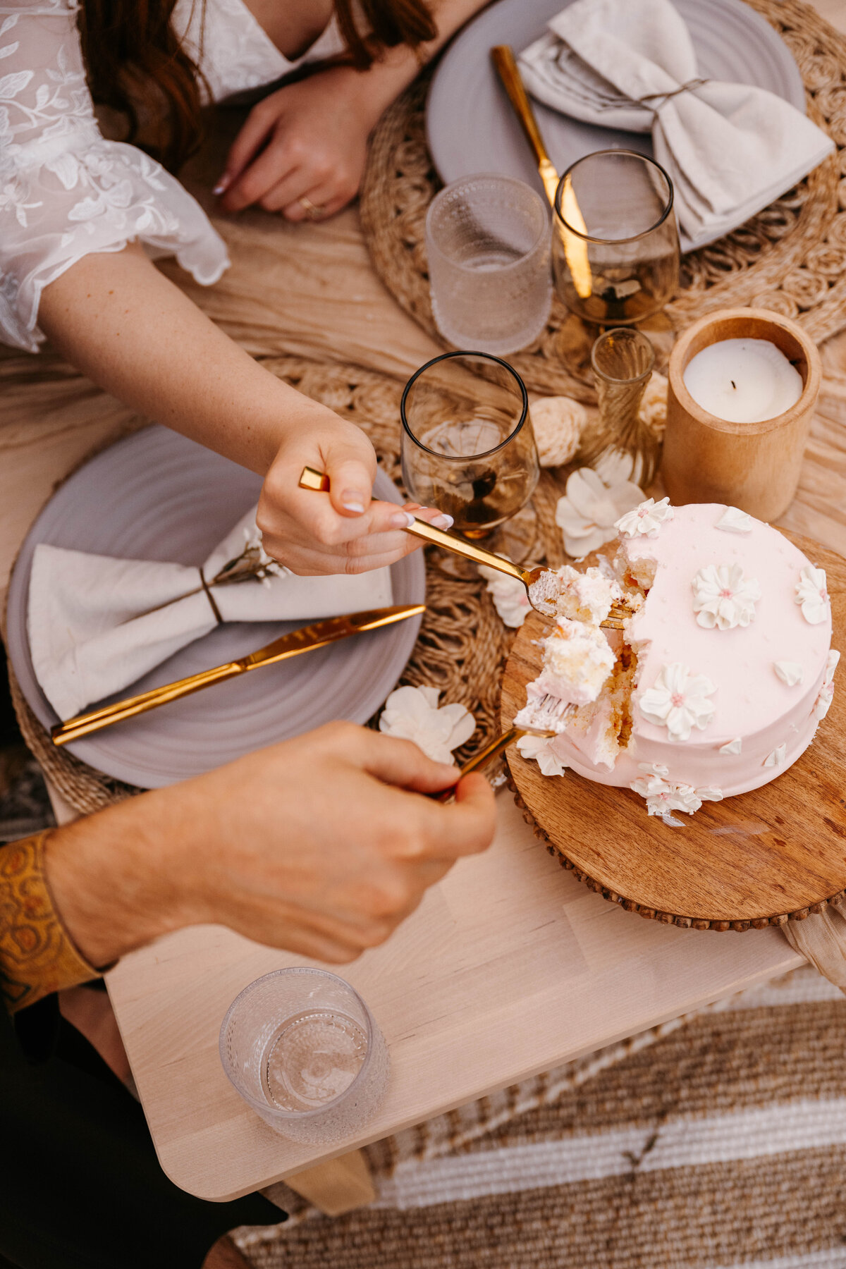 Bride and groom use forks to eat straight from the wedding cake. The Greenhouse on Strawberry Lane | Nova Scotia