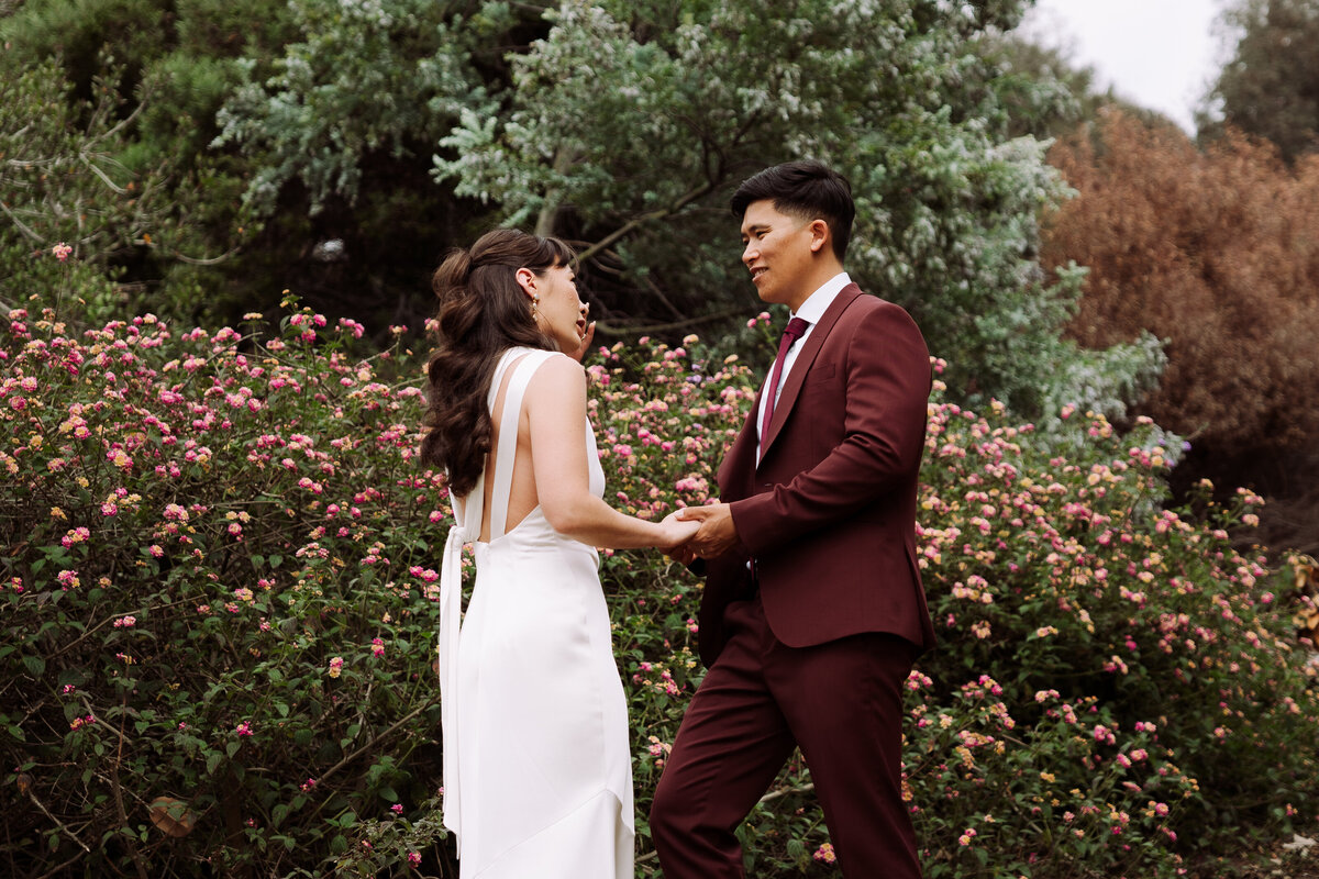 happy bride and groom holding hands outside in San Diego