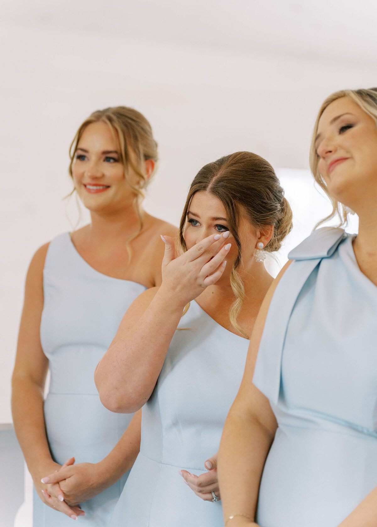 bridesmaids reacting to seeing bride in dress
